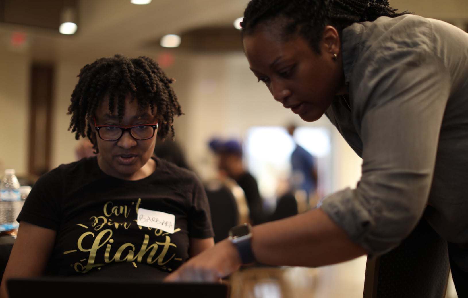 Photo of a Blacktocat mentoring a “FLOSS and Code” participant.